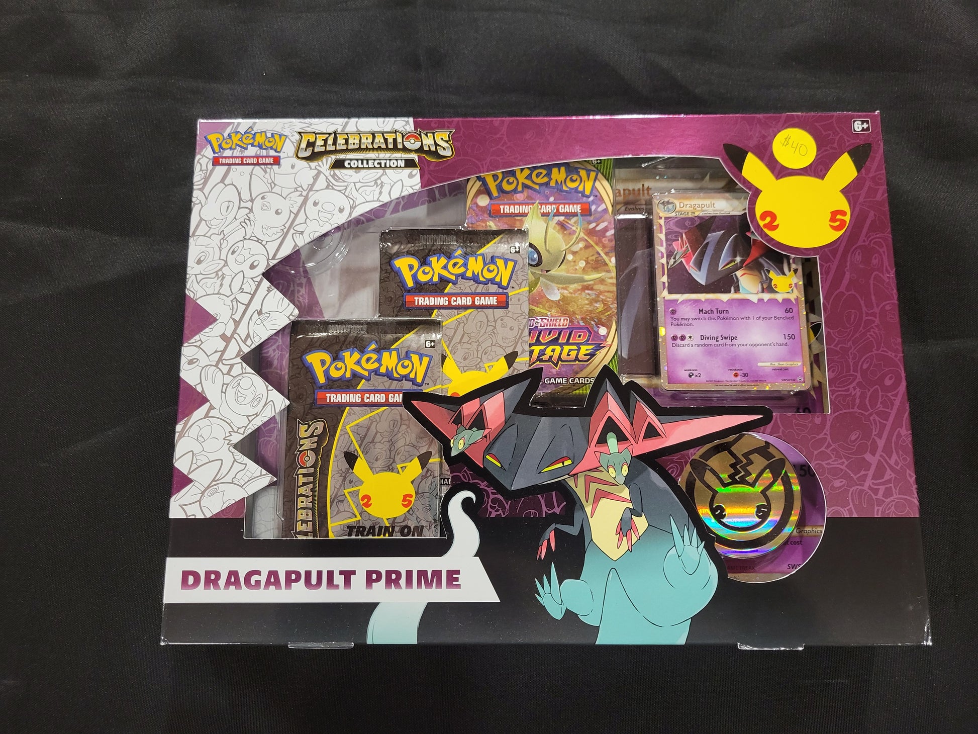 Each Dragapult box comes with one oversized Dragapult card, one Celebrations Dragapult card, one online code card, two Celebrations packs and one tcg pack.