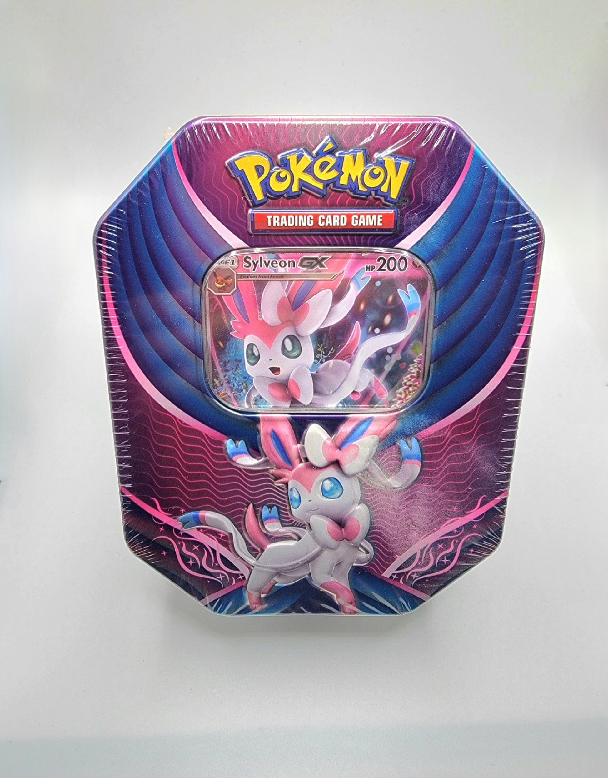 Each Sylveon GX Tin comes with one foil promo card of Sylveon GX, four TCG packs, and one online code card.